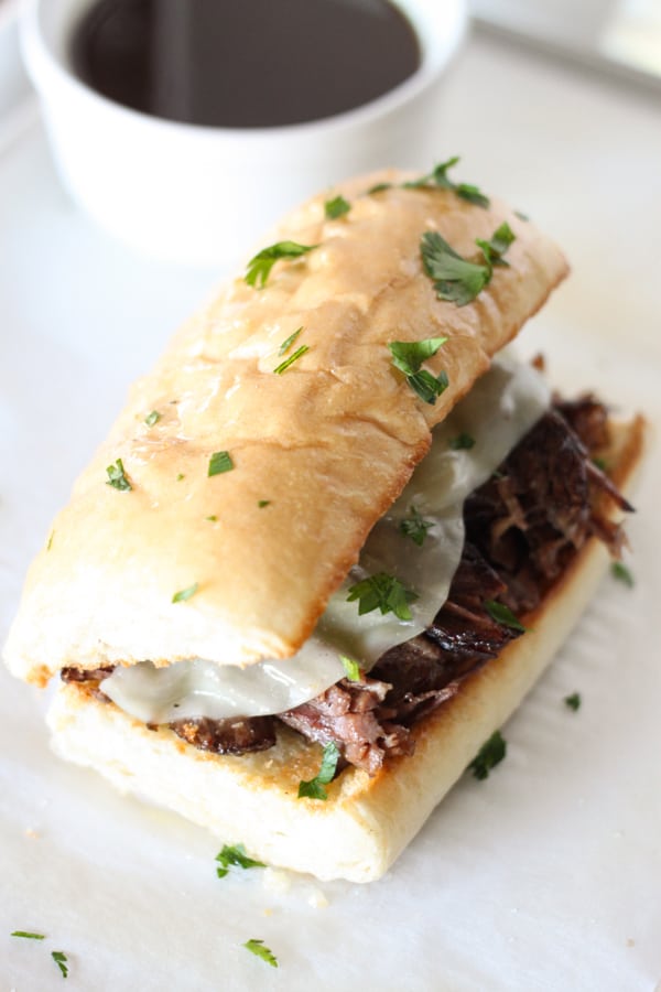 Instant Pot Pressure Cooker French Dip Sandwiches - Tender chunks of beef roast topped with melty cheese on a toasted garlic bread roll! 