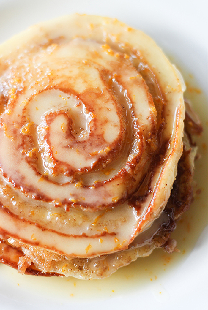 Orange Sweet Roll Pancakes -Tender fluffy pancakes, bursting with bright orange flavor and a buttery cinnamon and sugar swirl.