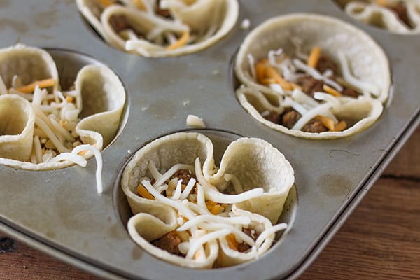 Breakfast Taco Cups - seasoned turkey sausage, shredded cheese and an egg baked in a tiny taco cup! 