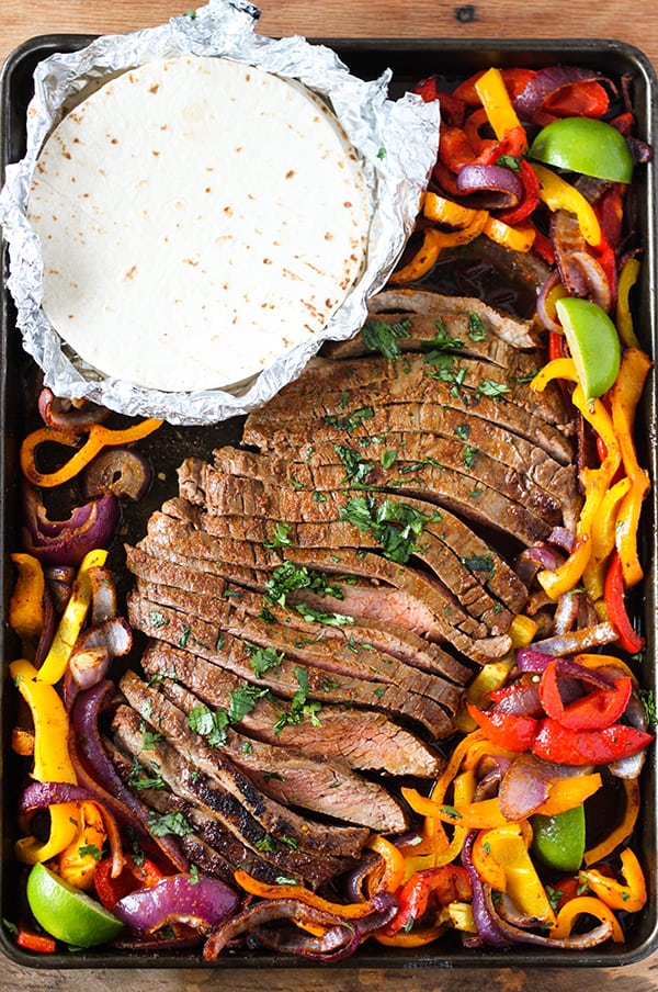 Sheet Pan Steak Fajitas - seasoned flank steak and tender onions and bell peppers in a one sheet pan dinner. So easy and delicious! 