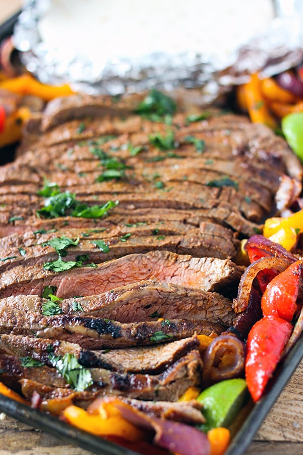 Sheet Pan Steak Fajitas - seasoned flank steak and tender onions and bell peppers in a one sheet pan dinner. So easy and delicious! 