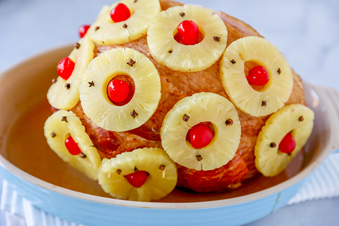 This Old-Fashioned Holiday Ham is the perfect Baked Ham Recipe. Spiral sliced ham glazed with brown sugar and pineapple juice and decorate with colorful pineapple slices and cherries.