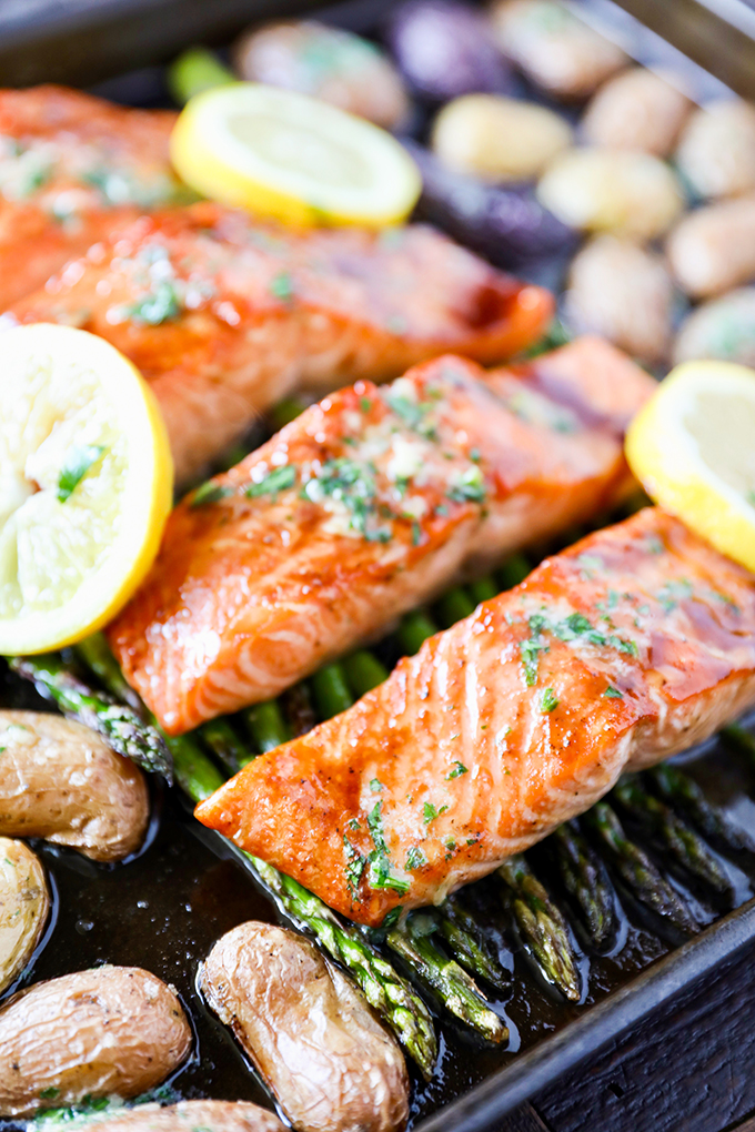 This Sheet Pan Salmon Dinner recipe is so easy to make and absolutely loaded with flavor! Glazed salmon with garlicky roasted potatoes and asparagus and everything cooks on the same pan.