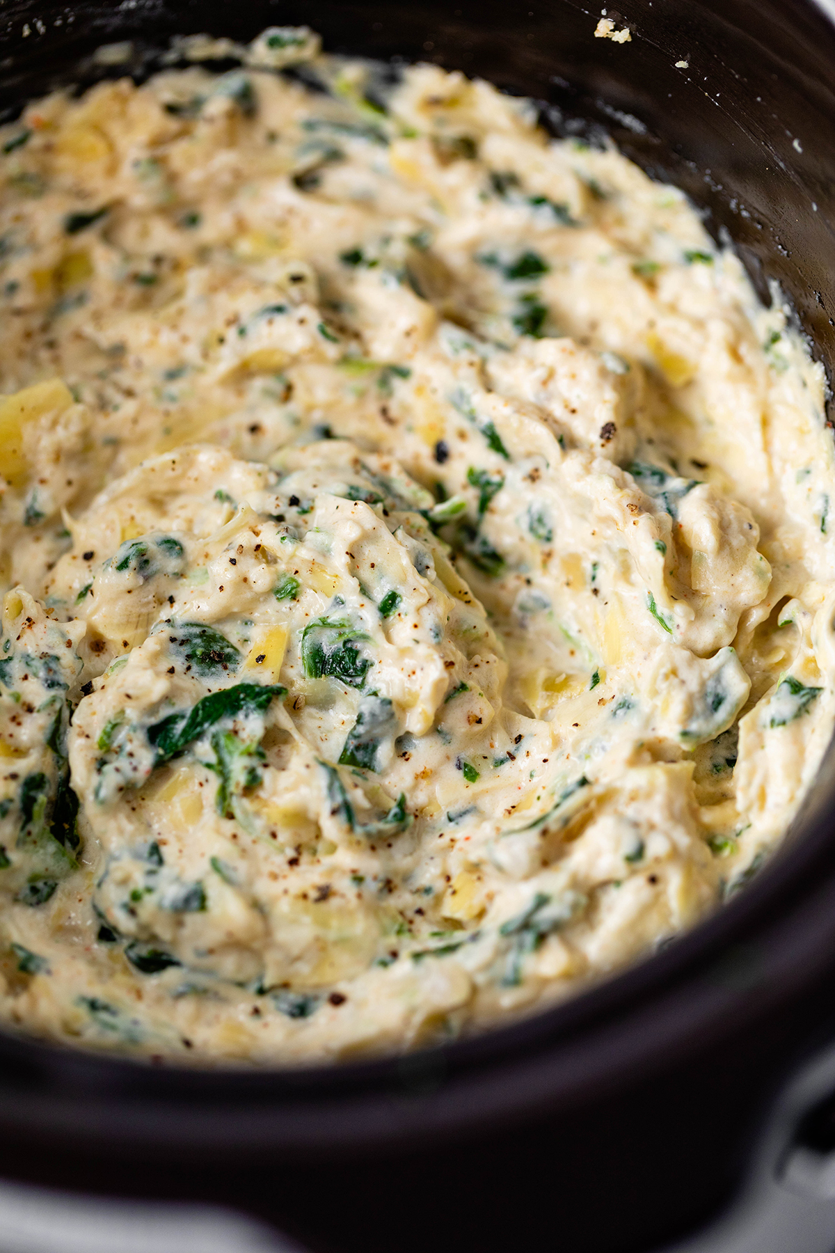 Slow Cooker Spinach Artichoke Dip - Creamy cheesy spinach artichoke dip stays hot and dippable in the slow cooker.
