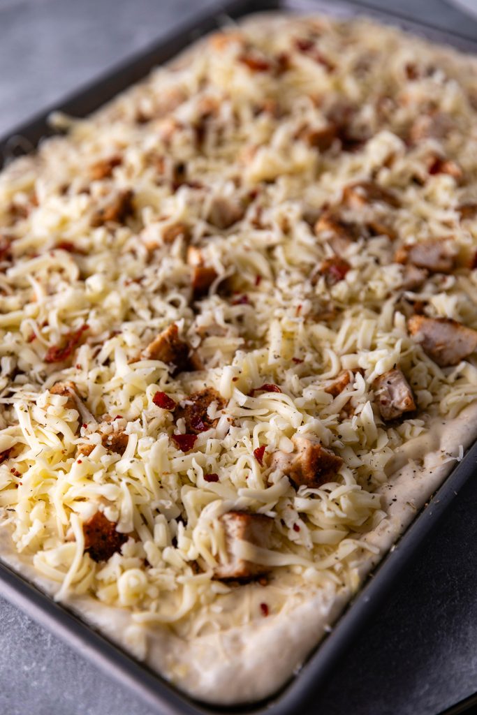 Assembling Garlic Chicken Alfredo Pizza